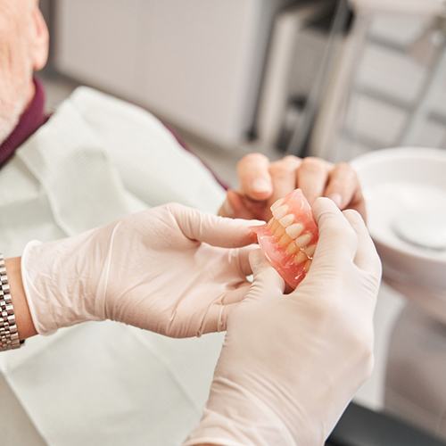 A man discussing dentures with his dentist