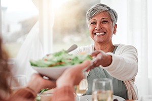 A woman serving salad
