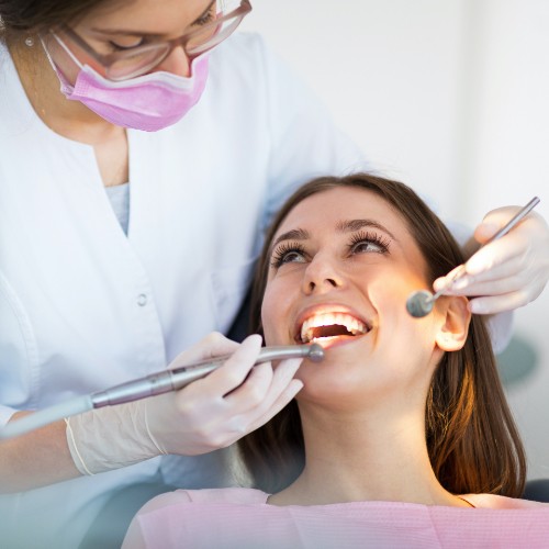 Woman receiving dental checkup to prevent dental emergencies