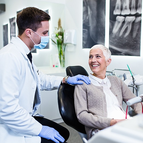 Dentist speaking to senior patient