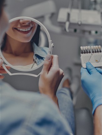 Dental patient looking at her smile in a mirror