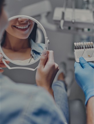 Woman looking at her smile in a mirror