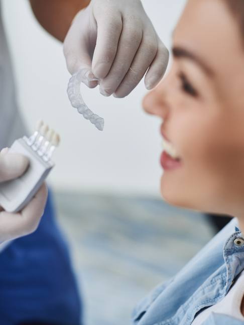 Dentist giving a patient an Invisalign tray