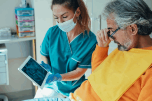 Dentist and patient reviewing an X-ray on a tablet