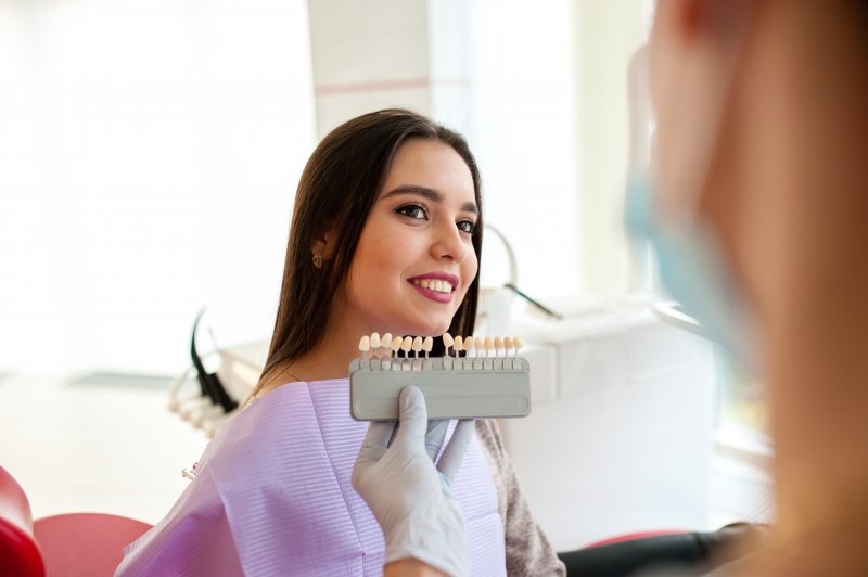A smiling woman being assessed for cosmetic dentistry